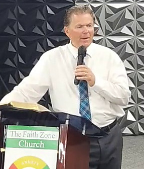Pastor John Fraser preaching at The Faith Zone Church